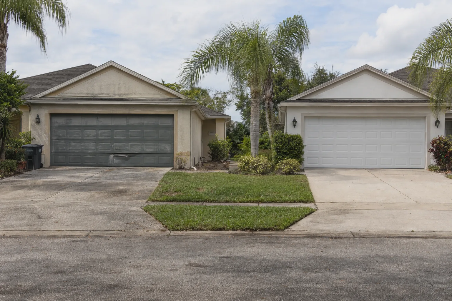 Side-by-side view of two suburban Orlando homes, one with a dented and faded aging garage door and one with a clean newly installed white garage door, photographed from street level in bright Florida sunlight